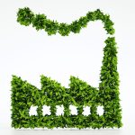 Icona di complesso industriale realizzata con foglie verdi per illustrare i criteri CSC in siti a uso misto.