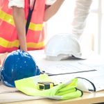 Riunione di coordinamento su progetti di cantiere con caschi protettivi: focus su governance dei rischi e prevenzione near miss.